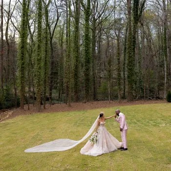 Image may contain: Clothing, Apparel, Human, Person, Fashion, Robe, Vegetation, Plant, Gown, Grass, Tree, and Woodland