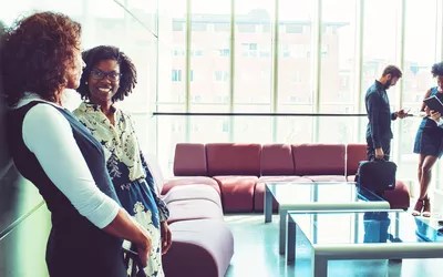 Businesswomen talking in the office building lobby