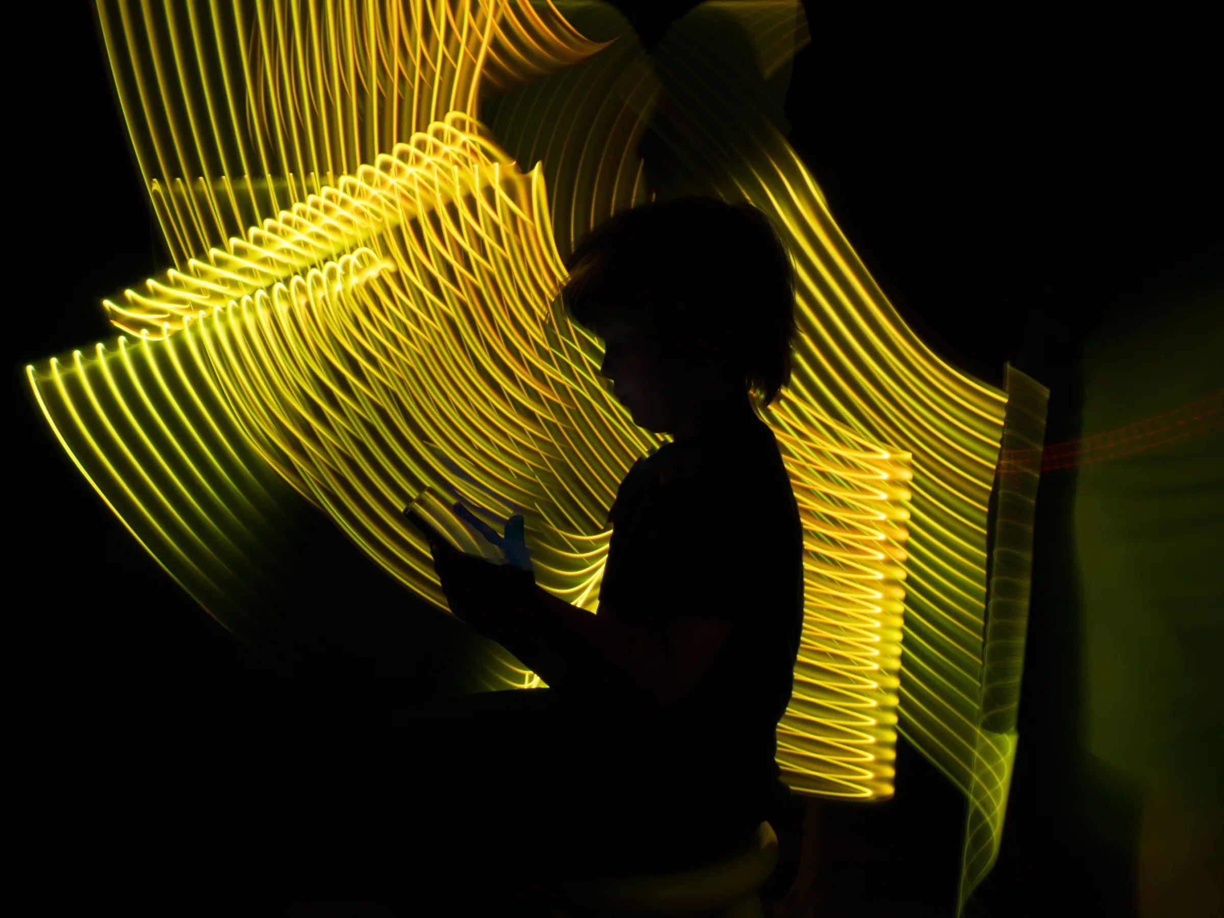Child shape looking a tablet in a futuristic yellow virtual environment